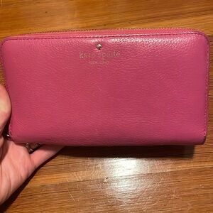 Kate Spade Pink Wallet with Gold Zipper and Striped lining.